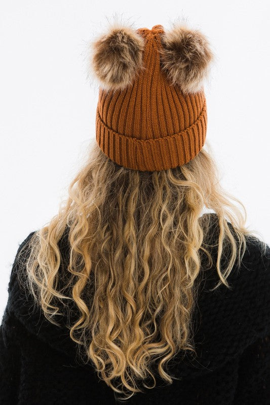 rust colour winter hat with 2 pom poms attached